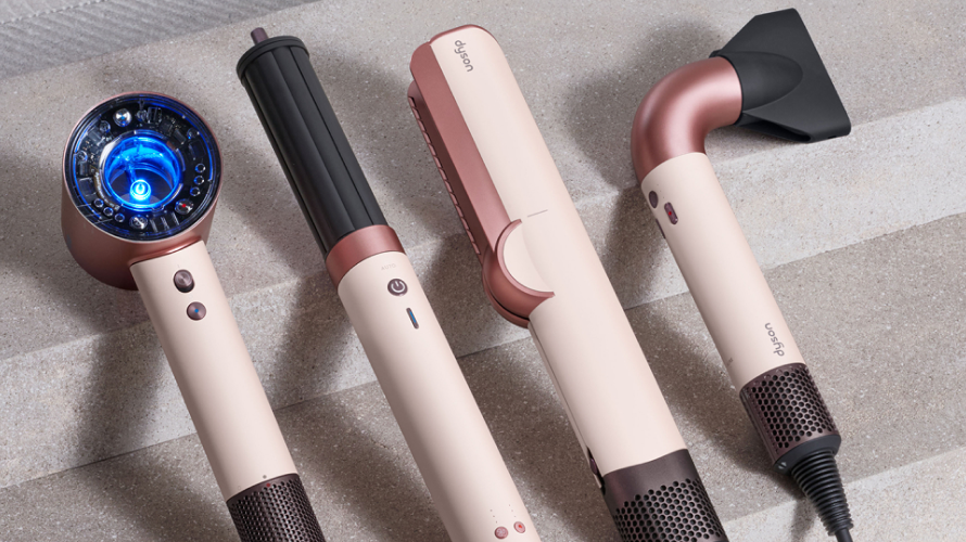 Woman vacuuming living room floor with Dyson vacuum