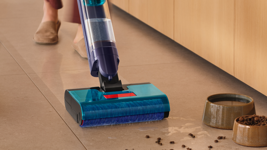 Dyson wet and dry vacuum cleaner is used to clean a pill on the tile floor.